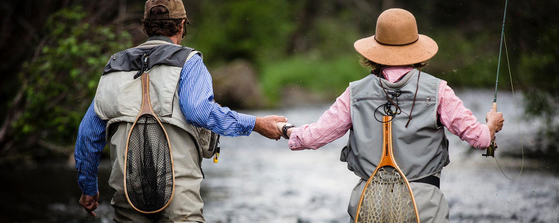 fishing guide helping woman