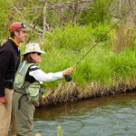 fishing guide helps guest set for the rainbow trout catch