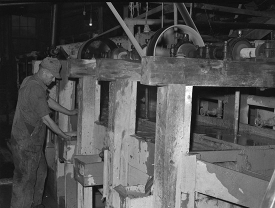 historic photo of miner running amalgamizing machine at wagon wheel gap mine