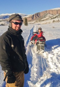 Smiling Brady Gibbons takes young son on Colorado snowmobile adventure!