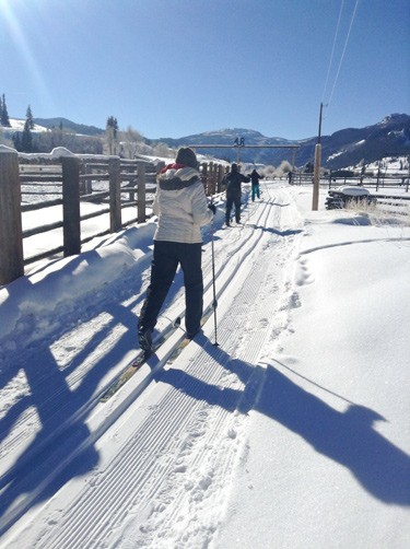 skiier starts out on colorado guest ranch groomed trail