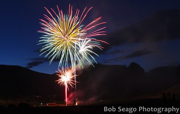 fireworks light up evening sky aove the small arts town of Creede Colorado