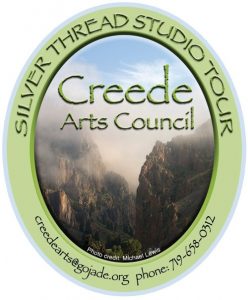 creede arts council studio tour logo. Creede cliffs in mist surrounded by a green oval with creede arts council name and webpage