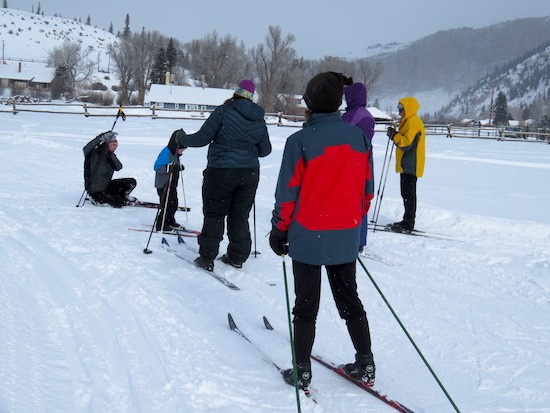Everyone watching as the instructor demonstrates how to get up after falling on XC skis