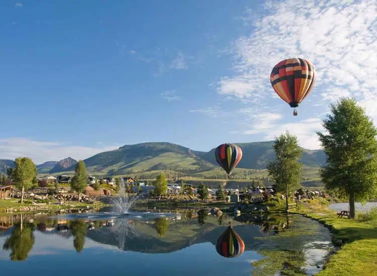 Hot air balloons over lake