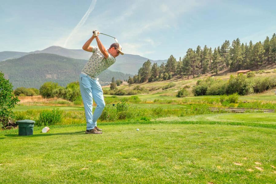 man swinging golf club