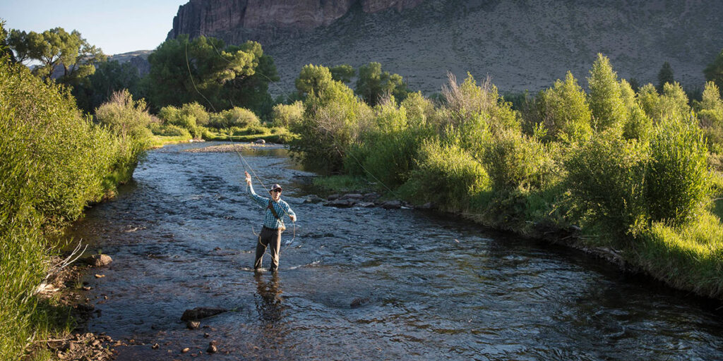 young man fly fishing alone on river