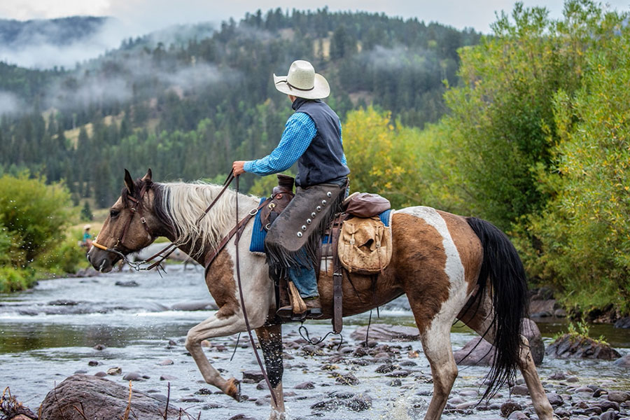 crossing river on horseback