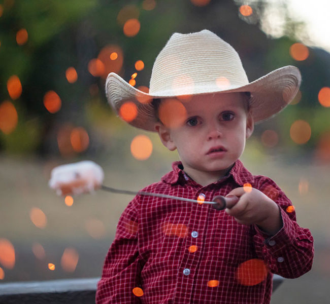 boy with marshmallow on stick